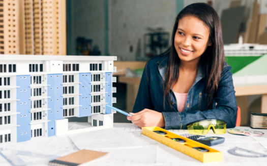 Learn The Path To Success: How To Become A Real Estate Agent In Nigeria 🏡🌟 - Smiling African-American Woman Showing Building Model